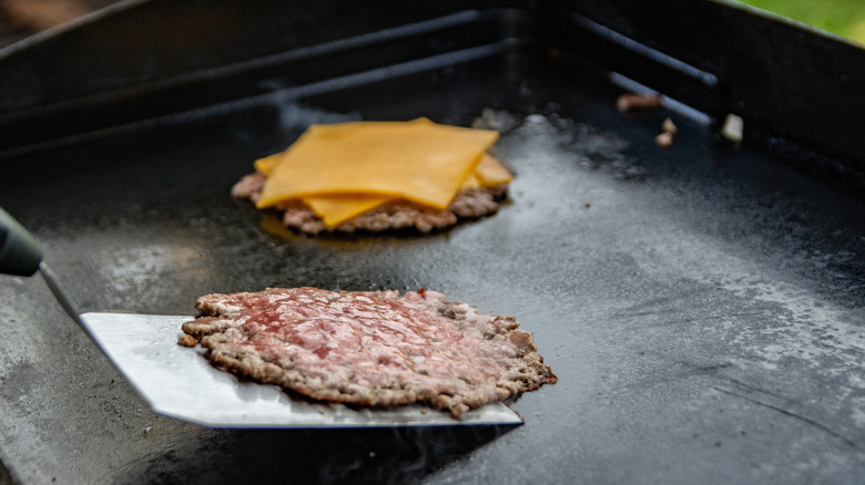 Smash burger patties on griddle