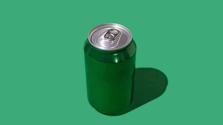 Green soda can on green background