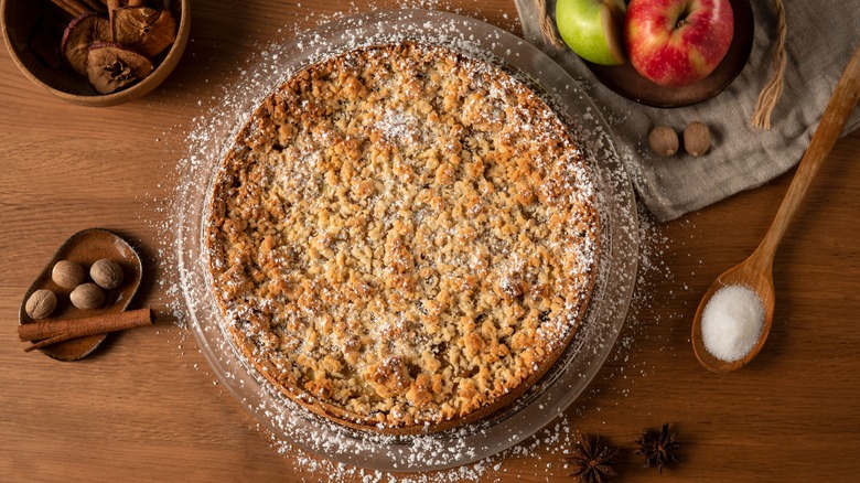 Apple pie with crumble topping and powdered sugar