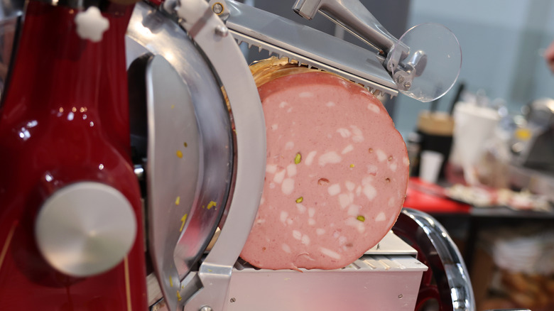 Mortadella getting sliced