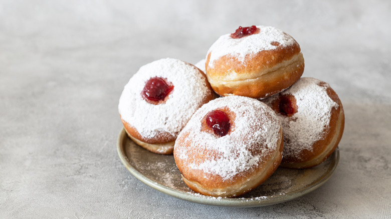 pile of jelly donuts on a plate