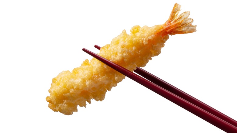 Tempura shrimp held with chopsticks