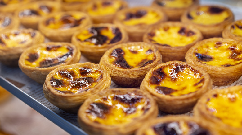 Portuguese-style egg tarts on baking tray