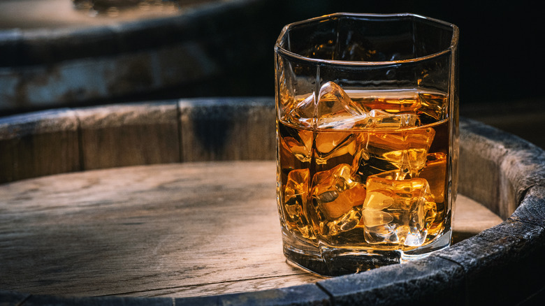glass of whiskey on barrel
