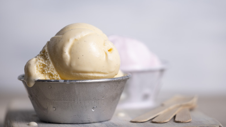 Scoop of vanilla ice cream in a metal bowl