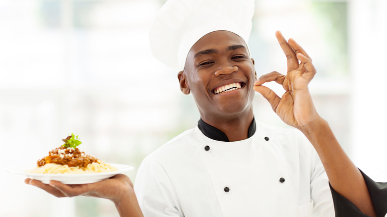 Chef holding plate of food