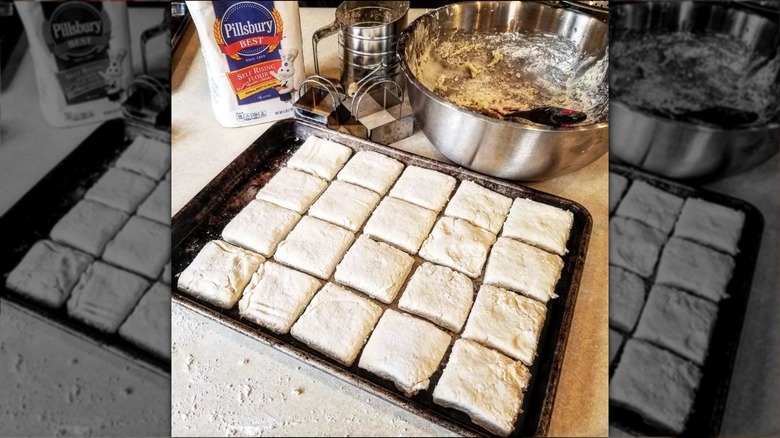 Biscuit dough cut into squares on baking tray.