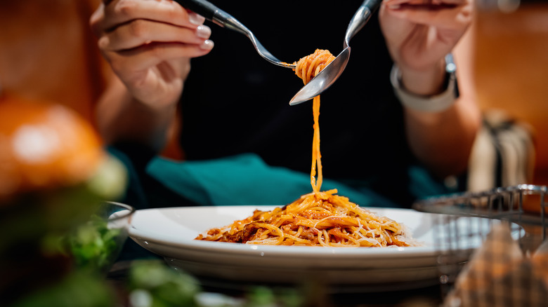 Person eating spaghetti