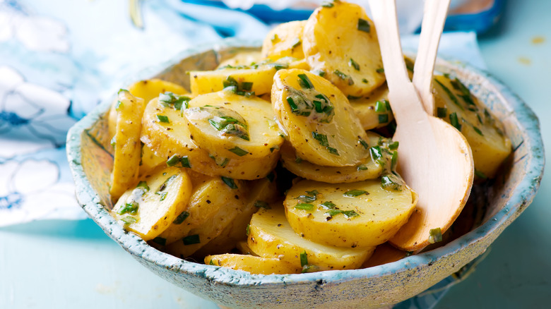 French-inspired potato salad with potatoes cut into thin rounds and dressed with vinegar and herbs