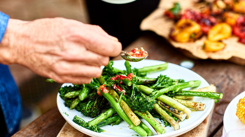 Tender stem broccoli on a plate with a chili topping