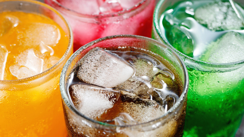 four different colored, bubbly sodas