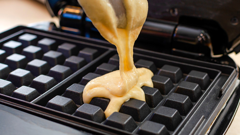 Spooning batter into waffle maker