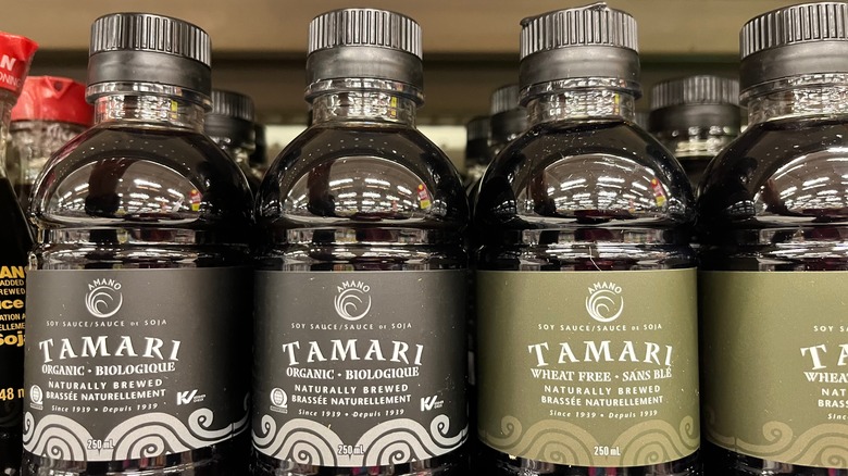 Tamari bottles on a supermarket shelf.
