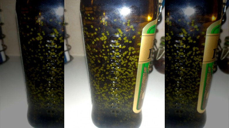 jar of olive oil with white spots 