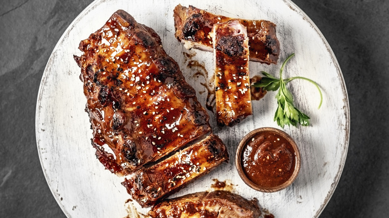 Barbecue ribs on a white wooden platter