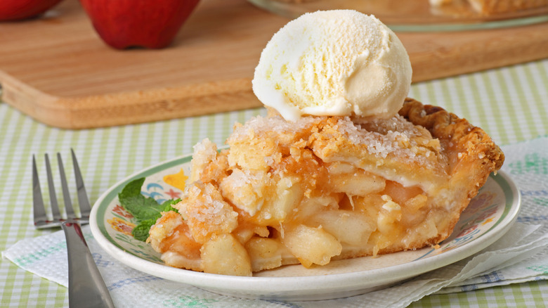 Slice of apple pie with ice cream on a plate