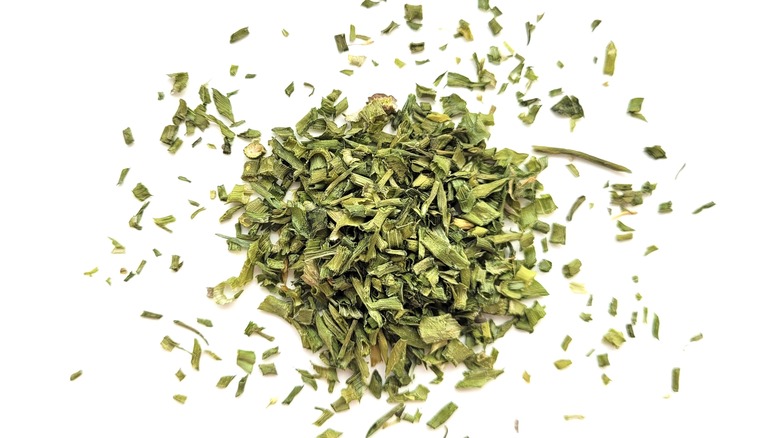 A pile of dried chives on a white background