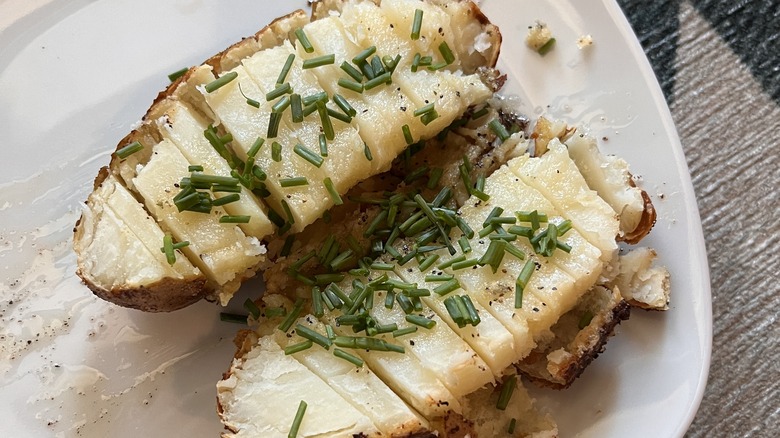 Chives sprinkled on two baked potato halves