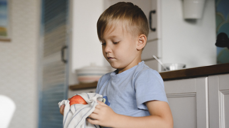 boy drying peach