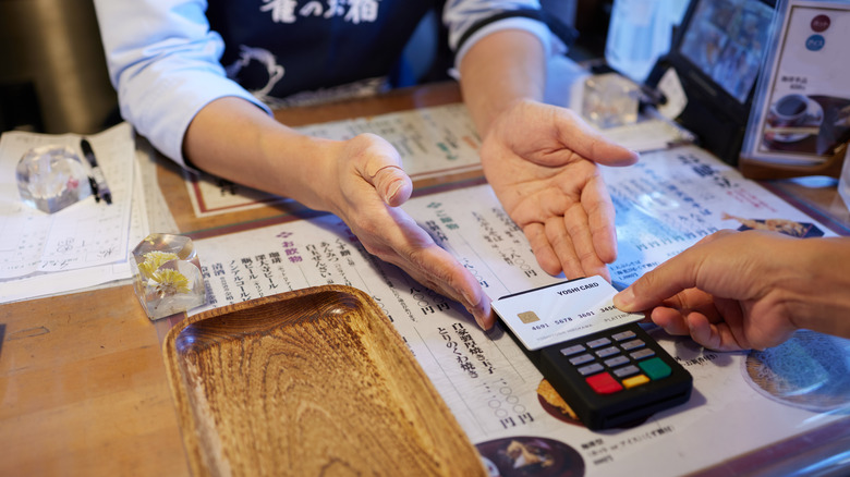 Customer paying at a Japanese restaurant