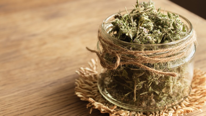 dried thyme leaves in jar