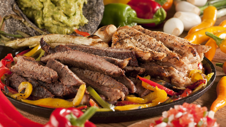 Fajitas on a sizzle platter with sides
