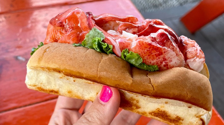 Connecticut lobster roll held in hand