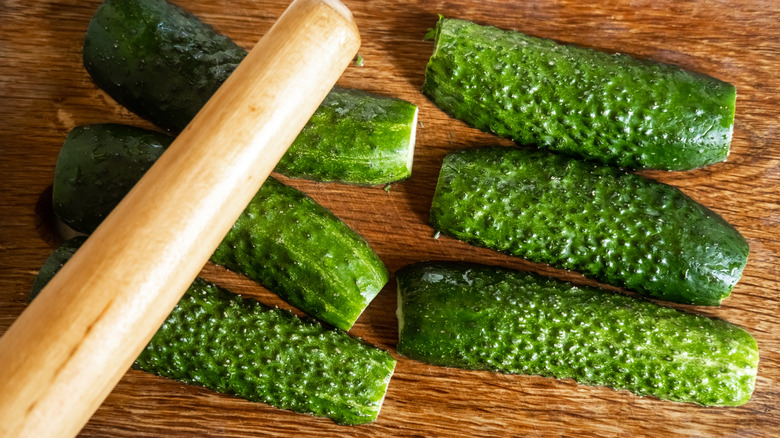 smashing cucumbers with a rolling pin