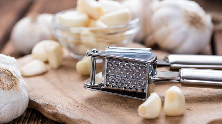 garlic press and peeled cloves