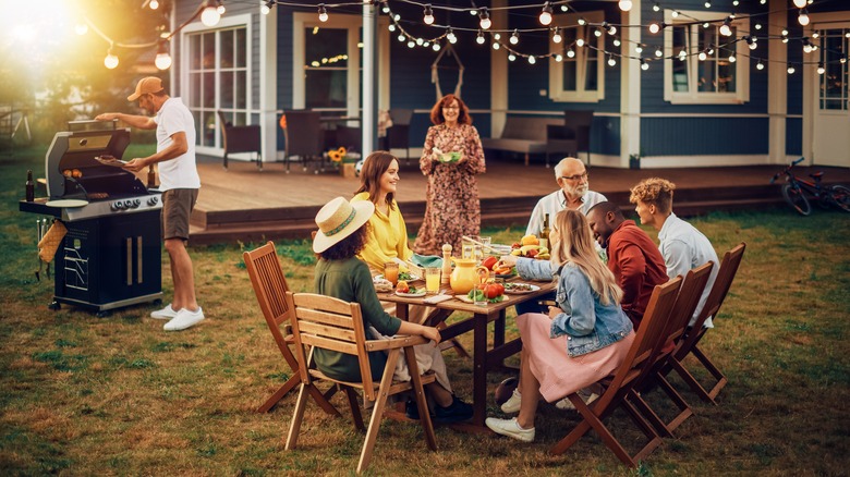 People gathered around a table at a BBQ