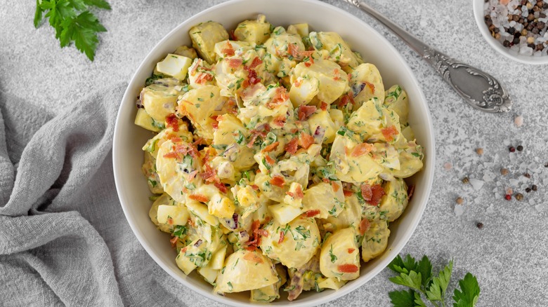 Potato salad next to herbs and seasoning