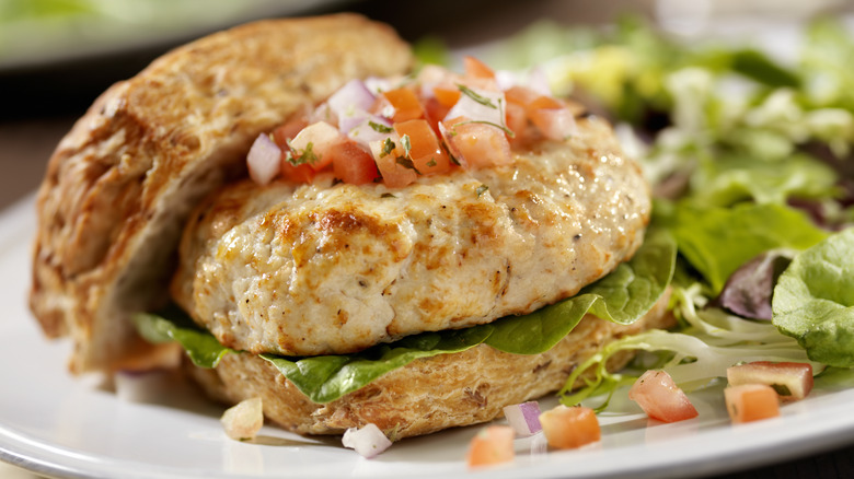 Turkey burger on a bun with lettuce and pico de gallo