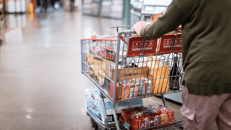 Costco shopper with full shopping cart