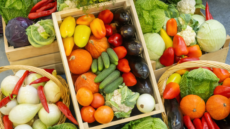 Bins are filled with vegetables at a farmers market.