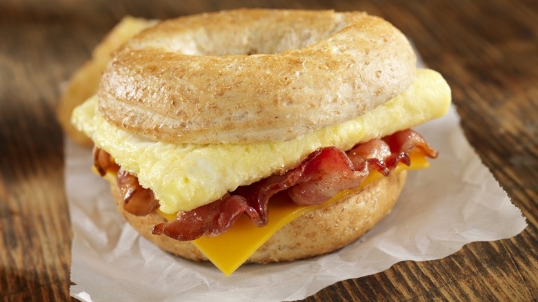 Breakfast sandwich with bacon, egg, and cheese on a bagel