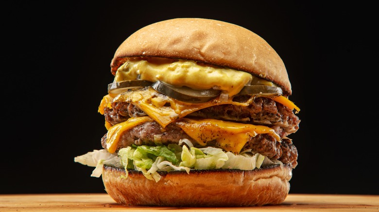 Double cheeseburger sitting on a table