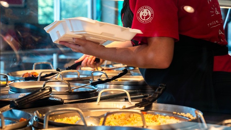 panda express worker plating an order