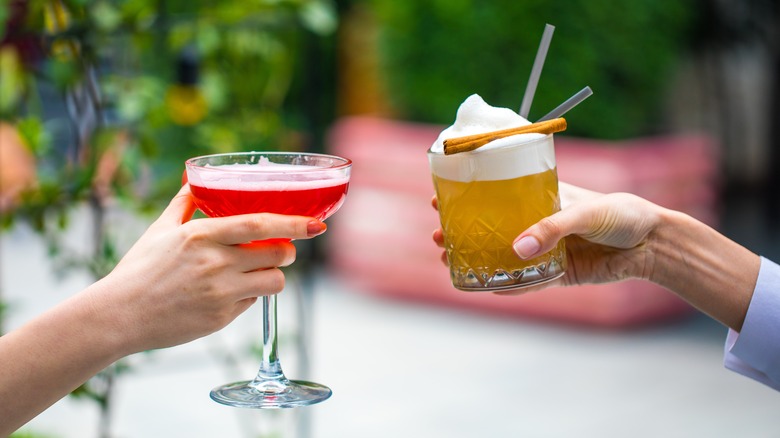 People toasting with cocktails