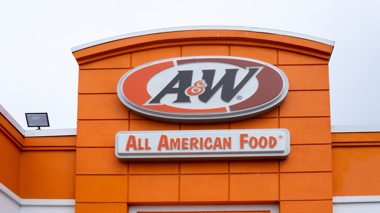 An A&W sign appears on restaurant building.