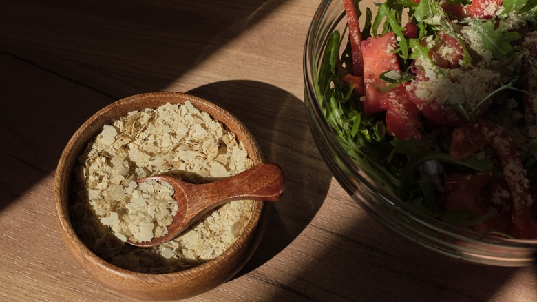 nutritional yeast flakes next to salad
