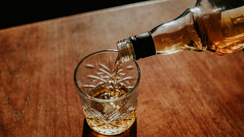 Pouring whiskey in a glass