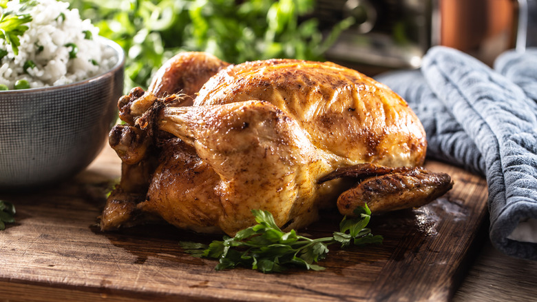 Whole roasted chicken on a cutting board