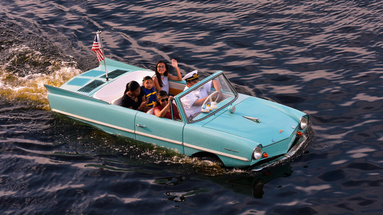 People riding in blue amphicar