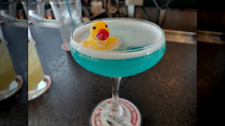 Blue cocktail topped with a rubber duckie