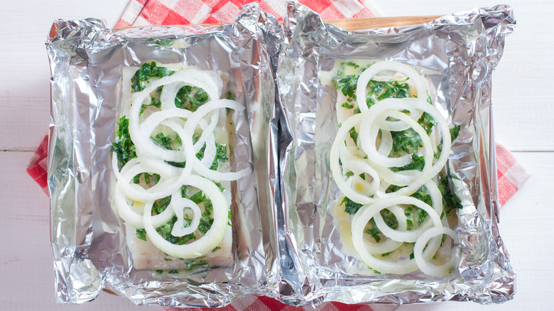 Prepping to grill cod with onions