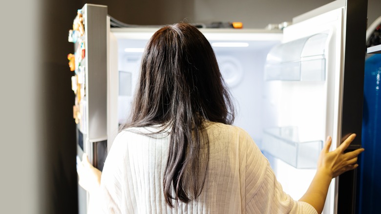 A woman looking into fridge