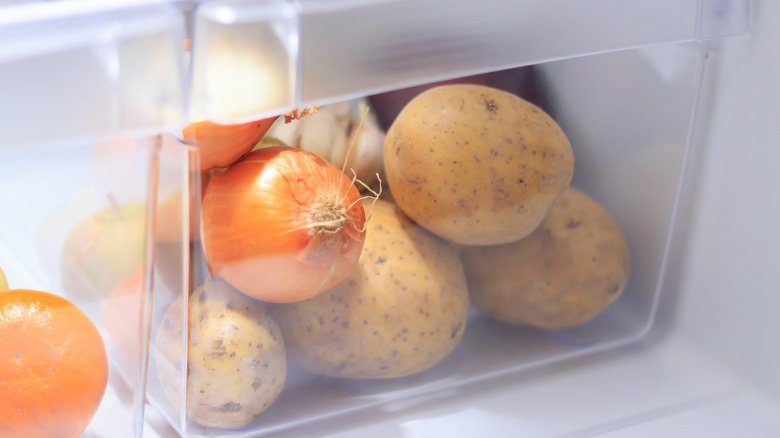 Onions and potatoes in refrigerator drawer