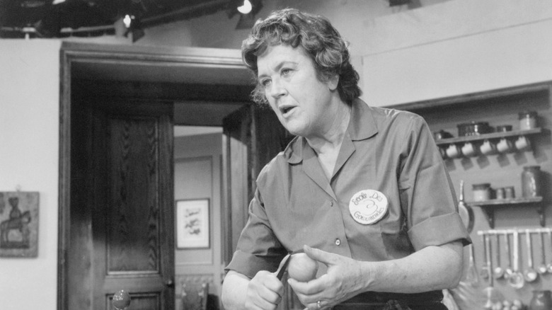 Black and white image of Julia Child peeling a vegetable