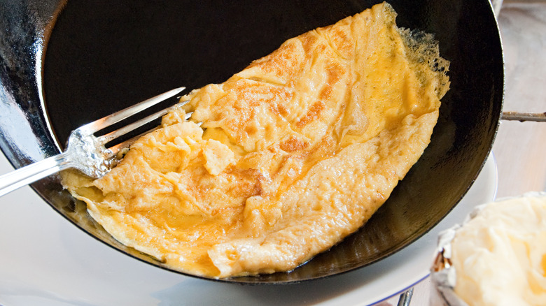 french omelette in a black pan