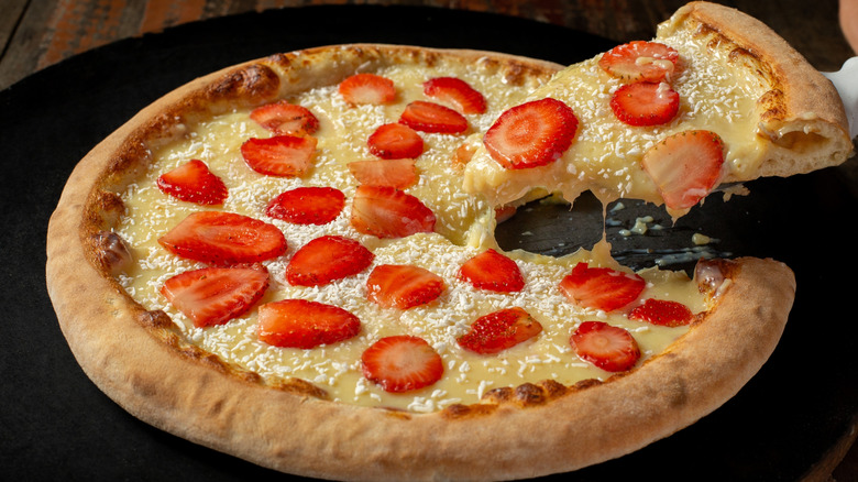 A white chocolate pizza covered in strawberries